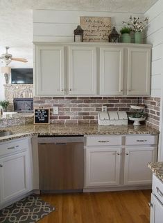 a kitchen with white cabinets and granite counter tops, wood flooring and wooden floors