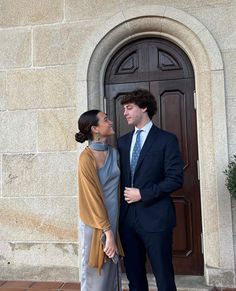 a man and woman standing in front of a door