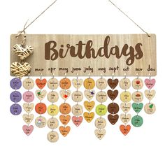 a wooden sign that says birthdays with hearts hanging from the front and back of it