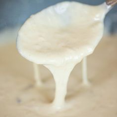 a spoon full of cream being held by someone