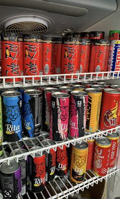 many cans of soda are stacked on shelves