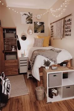 a bedroom with lights strung above the bed and an open bookcase on the floor