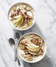 two bowls filled with oatmeal topped with apples