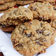 chocolate chip cookies stacked on top of each other in front of more oatmeal cookies