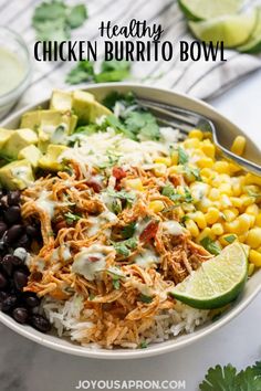 a white bowl filled with rice, black beans and avocado garnish