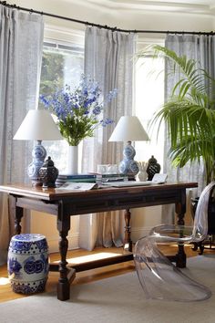 a living room filled with lots of furniture and flowers in vases on top of a table