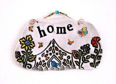 a white embroidered purse with the words, the rogans on it's side