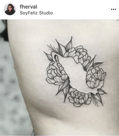 a black and white photo of a woman's stomach with flowers in the middle