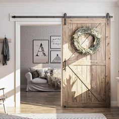 an open door with a wreath on it in a living room next to a chair