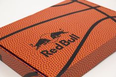 an orange and black basketball with the word redbull on it's side