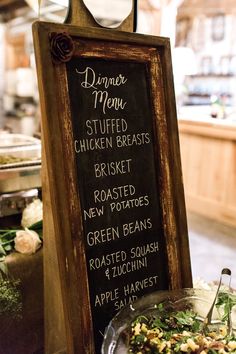 a sign that says dinner menu next to a plate of food on a table in a restaurant