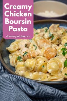 creamy chicken bourssin pasta with parmesan cheese and herbs in a bowl