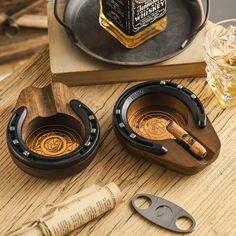 two wooden containers on a table with some bottles and other items around them, including a bottle opener