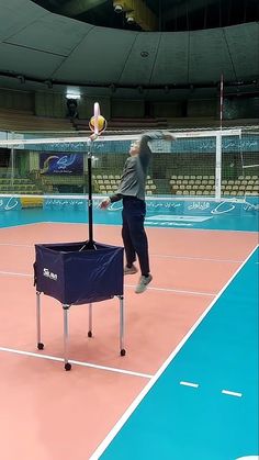 a man jumping up to hit a tennis ball with a racket on a court