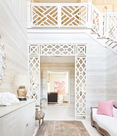 the interior of a house with white walls and stairs