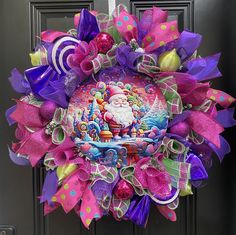 a christmas wreath on the front door with purple and green bows, santa's sleigh