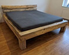 a bed made out of wood in a room