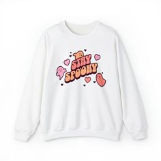 Embrace the Halloween season with our Stay Spooky Retro crewneck! This unique and adorable sweatshirt is perfect for anyone who loves all things spooky and cute. Crafted from high-quality fabric, it's comfortable for everyday wear or as part of your Halloween costume. The retro-style font adds a touch of nostalgia, while the cute ghosts and hearts give it a charming and playful twist. It's the ideal crewneck to show your love for Halloween in a sweet way. Ideal for any situation, a unisex heavy blend crewneck sweatshirt is pure comfort. With a loose fit, these crewnecks run true to size. These garments are made from 50% polyester and 50% cotton. This combination helps designs come out looking fresh and beautiful. The collar is ribbed knit, so it retains its shape even after washing. There Kawaii Letter Print Sweatshirt For Fall, Trendy Character Print Sweatshirt For Fall, Trendy Crew Neck Sweatshirt With Character Print, Trendy Fall Sweatshirt With Character Print, Kawaii Graphic Print Crew Neck Sweatshirt, Fall Kawaii Graphic Print Sweatshirt, Fall Kawaii Sweatshirt With Graphic Print, Cute Crew Neck Sweatshirt With Funny Print, Cute Sweatshirt With Funny Print And Crew Neck