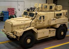 an army vehicle is parked in a garage