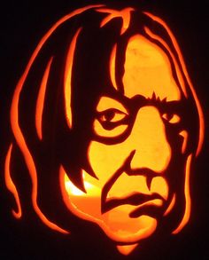 a pumpkin carved to look like the face of john lee jones, with long hair and glasses