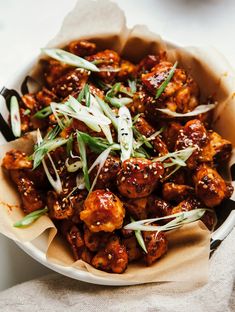 a bowl filled with fried food on top of a table