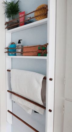 an open closet door with towels and other items on the shelves