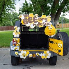 the back end of a jeep decorated with bees and honeycombs