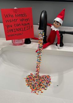 an elf is sitting in the sink with sprinkles