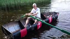 an older man sitting on top of a boat in the water with oars attached to it