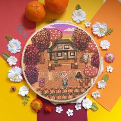 an orange and white flowered background with a cross - stitch pattern on the hoop