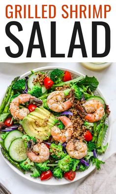 this grilled shrimp salad has broccoli, cucumber, tomatoes and avocado