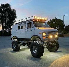 an off - road vehicle with lights on it's roof is parked in a parking lot