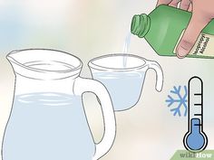 a pitcher pouring water into two mugs