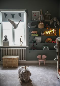 a baby's room with stuffed animals on the shelves and toys in the corner