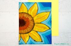 a painting of a yellow sunflower on a blue and yellow background next to a piece of paper