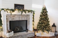 a living room with a christmas tree and fireplace