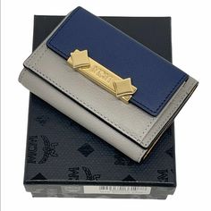 Brand New Authentic With Box, Dust Bag, Cards And Tags Free Fast Shipping ! -Mcm Item Code Inside Wallet: Mya9ada05ez001 -Grey And Navy Luxurious Leather, Yellow Leather Interior -Mini Card Case Style Wallet -Coin Compartment -Long Bill Compartment -Three Card Slots -Gold Tone Hardware With Mcm Logo Engraved Item #2049 Modern Card Holder With Original Box As Gift, Modern Card Holder With Original Box For Gift, Designer Blue Card Holder For Everyday, Formal Blue Rectangular Wallets, Elegant Blue Bifold Card Holder, Blue Rectangular Wallets For Formal Occasions, Elegant Gray Bifold Wallet, Elegant Gray Rectangular Wallet, Luxury Blue Wallets As Gift