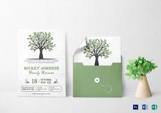 an envelope with a tree on it next to a card and flower in a vase