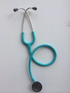 a blue stethoscope laying on top of a white surface