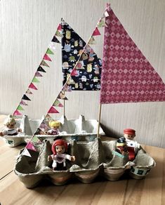 an egg carton filled with toys on top of a wooden table