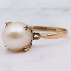 This vintage Art Deco Japanese 14K Gold ring features an 8.3mm pearl. This ring is a size 7.25 and weighs 2.4 grams. This piece is in great vintage condition with light wear. Item is marked as shown.  Follow me on Instagram for special deals ;) @mindilynjewelry Antique 14k Stamped Pearl Ring For Wedding, Antique 14k Stamped Pearl Wedding Ring, Antique Pearl Ring For Wedding, Vintage 14k Gold Pearl Ring, Vintage Pearl Ring For Gift, Vintage Oval Pearl Ring For Wedding, Vintage Yellow Gold Pearl Ring For Formal Occasions, Classic Hallmarked Pearl Ring, Vintage Oval Yellow Gold Pearl Ring