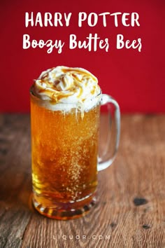 a glass mug filled with harry potter boogy butterbees on top of a wooden table