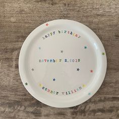 a white plate with the words happy birthday written in multicolored letters on it