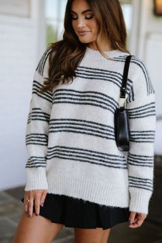 Expertly crafted for warmth and style, the Daphne sweater in cream and charcoal boasts a classic striped design with a cozy round neckline and ribbed trim. Stay on-trend and comfortable all season long! 59% recycled polyester, 26% nylon, 9% wool, 5% polyester, 1% spandex Model is 5'3" with a 32" bust, 25" waist, and 38" hips and wearing a small. Maxi Tops, Dresses By Length, Short Rompers, Top Sales, Stripes Design, Skirt Pants, Set Dress, Round Neckline, Dresses For Sale