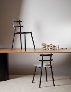 two chairs sitting on top of a wooden table