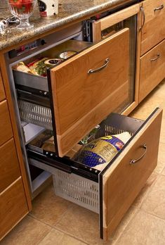 an open drawer in the middle of a kitchen