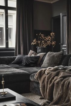 a living room filled with lots of furniture and a vase on top of the couch