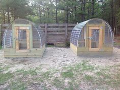 two chicken coops in the middle of a yard