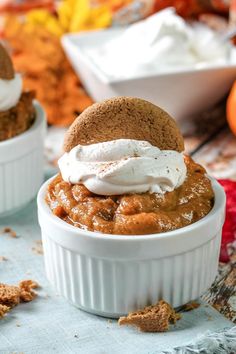 two small white bowls filled with food on top of a table