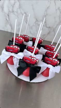 the cake is decorated with red and black fondant cars